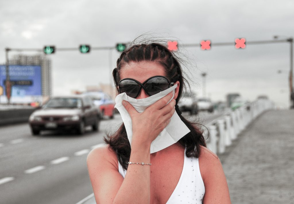 Feinstaub - Woman fighting smog along city streets.